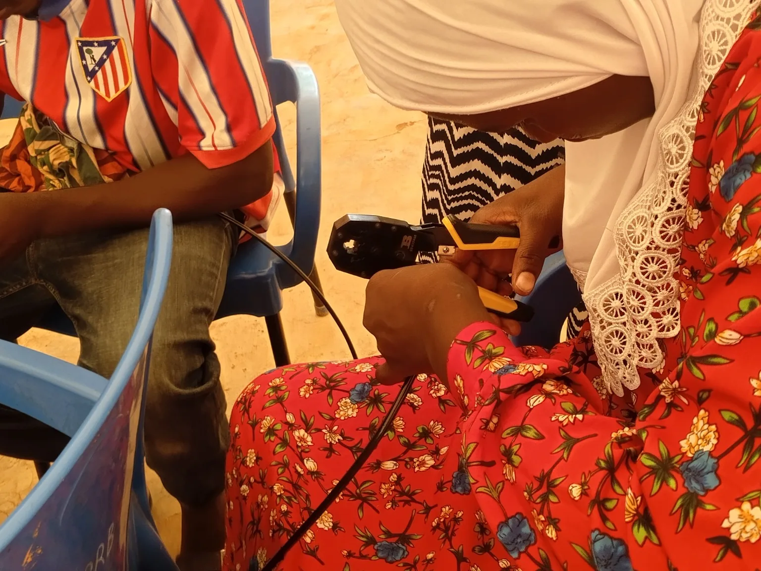 Young participant learning Ethernet cable termination during a networking training